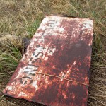 A rusty old sign that reads "Property of D&RGWRR  No Trespassing"
