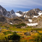 Autumn colors carpet the valley floor under Navajo and Apache peaks.