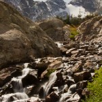 Meltwater from Isabelle Glacier running over the rocks under the watch of Navajo Peak