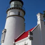 Cape Perpetua lighthouse under a flawless blue sky.